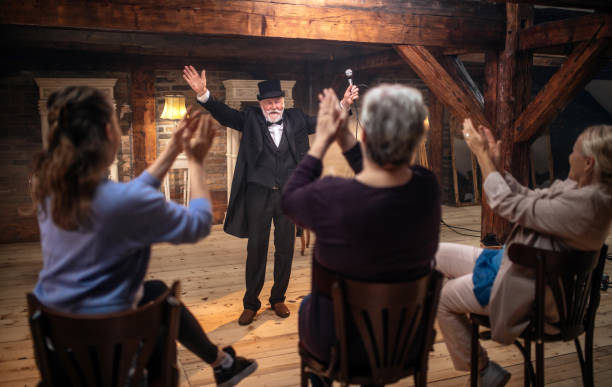 istock Senior man actor performing on stage for a an audience 1488369683