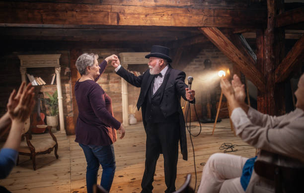 istock Senior man actor performing on stage for a an audience 1488369693