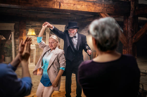 Senior man actor performing on stage for a an audience