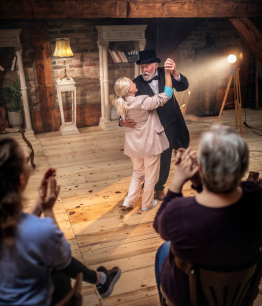 istock Senior man actor performing on stage for a an audience 1488369726