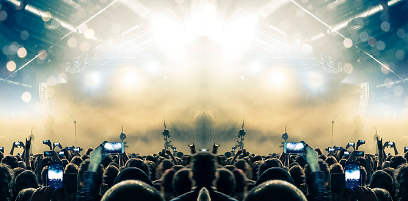 Music concert stage in a venue with crowd of people.