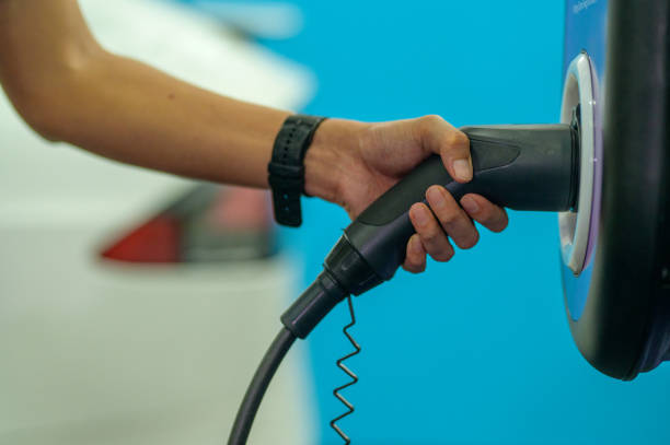 istock Hand holding electric plug-in charger 1488370038