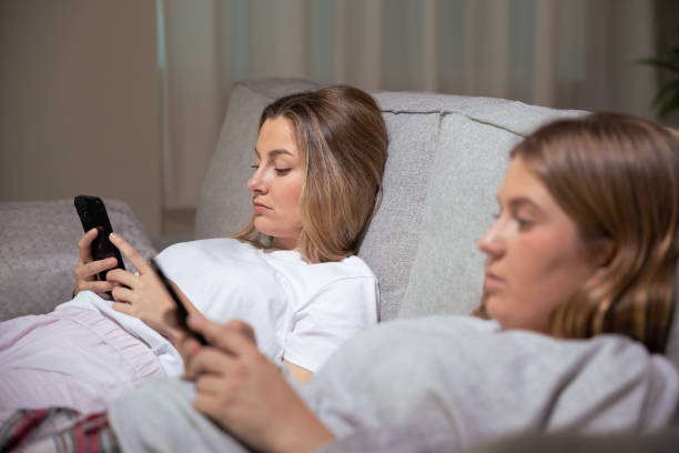 istock Bored women using phones at night 1488372151