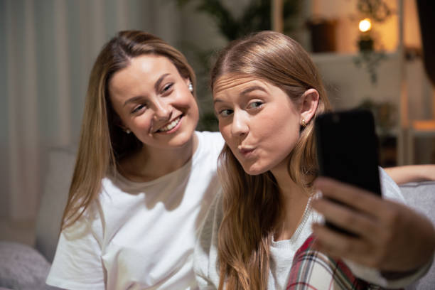 istock Two friends taking selfie at home 1488372163