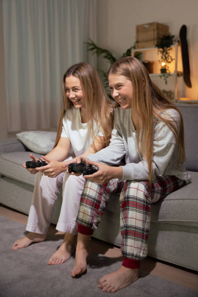 istock Sisters wearing pajamas playing video game 1488372186
