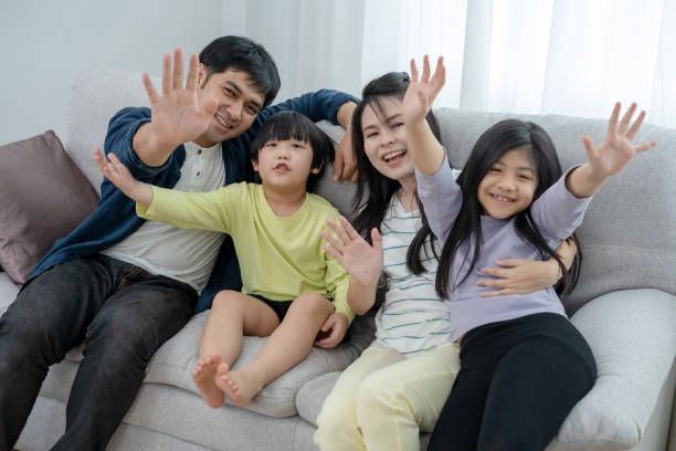 asian family with bright smiles and happy faces. happy time together of parents and children - two parent family indoors home interior domestic kitchen imagens e fotografias de stock