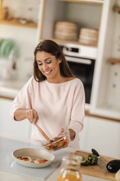 istock Woman Preparing A Healthy Meal In The Kitchen 1488372970