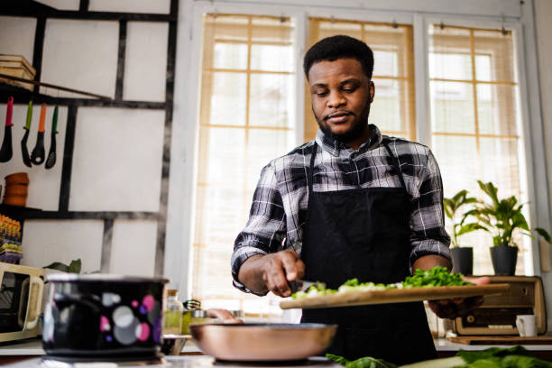 istock Young man cooks healthy meal 1488375181