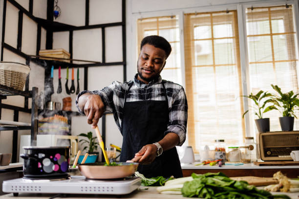istock Man frying vegetables in pan 1488375346