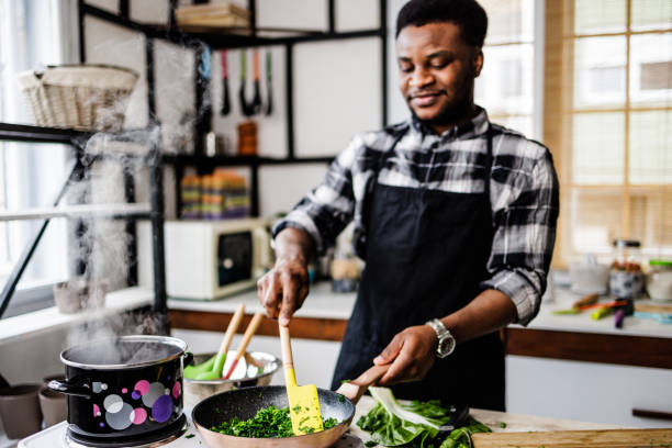 istock Happy man cooks at home 1488375360