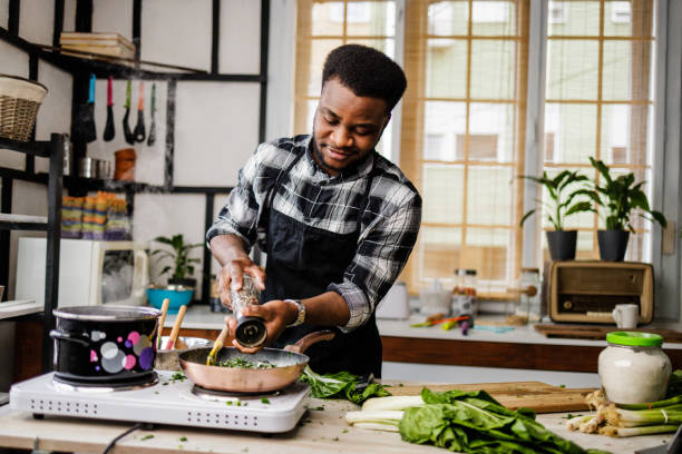 istock Smiling man puts pepper in meal 1488375363
