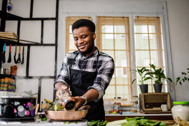 istock Man puts spices in his meal 1488375382