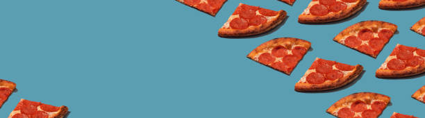 istock Pepperoni slice pizza pattern. Food pattern with hard shadows. Wide banner. Panoramic 1488375422