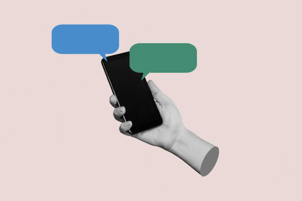 istock Hand holding mobile phone with a speech bubble. . Blank with empty copy space for text 1488376215