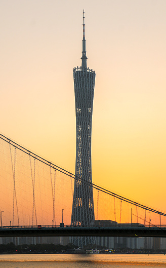 Canton Tower as seen through the Liede Bridge at sunset, modern building and landmark of Guangzhou, huge metropolis in south China. Second tallest tower in the world.