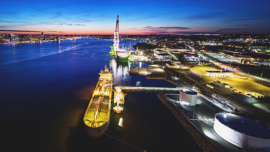 Aerial view of a n oil/chemical tanker docked in twilight.