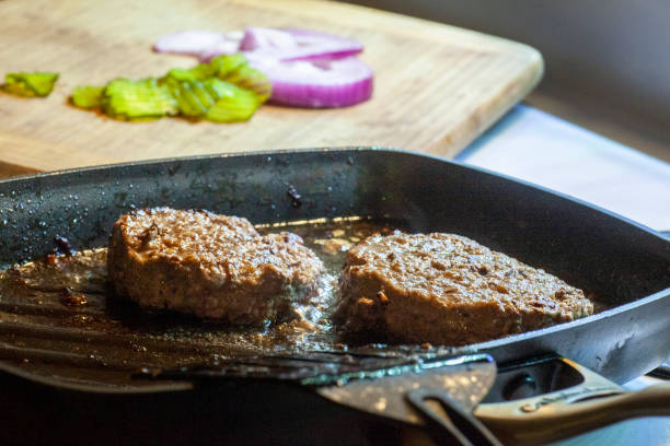 istock HAMBURGERS COOKING ON GRIDDLE 1488379408