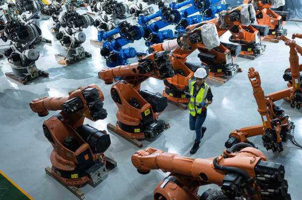 istock A female engineer installs a program on a robotics arm in a robot warehouse. And test the operation before sending the machine to the customer. 1488380764