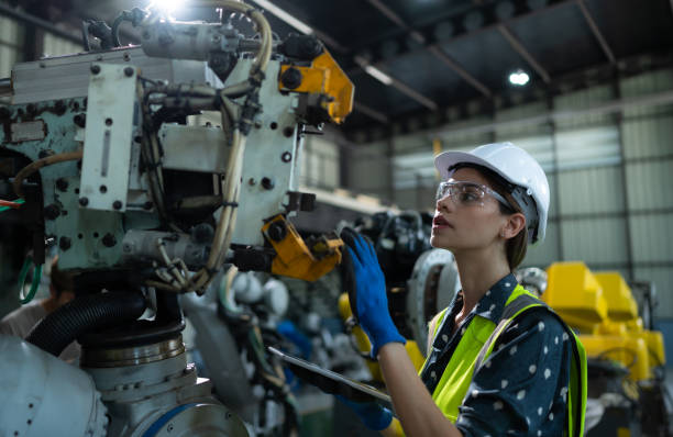 istock A female engineer installs a program on a robotics arm in a robot warehouse. And test the operation before sending the machine to the customer. 1488380778