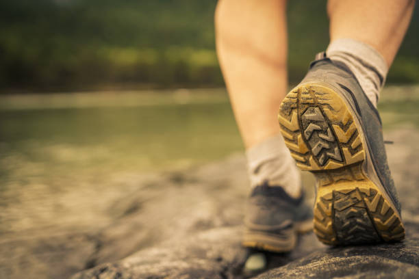 men's footsteps on the beach of river