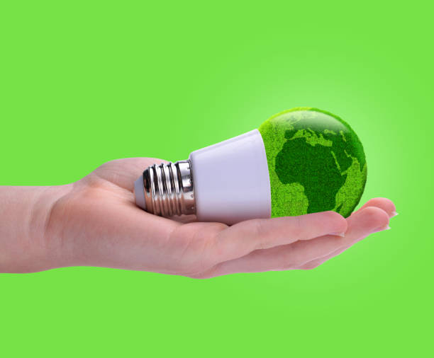 istock Eco LED bulb in hand isolated on a green background. 1488381269