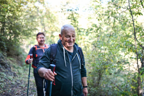 istock Senior Hikers Sharing Jokes And Fun Casual Conversation While Roaming Through Forest 1488381413