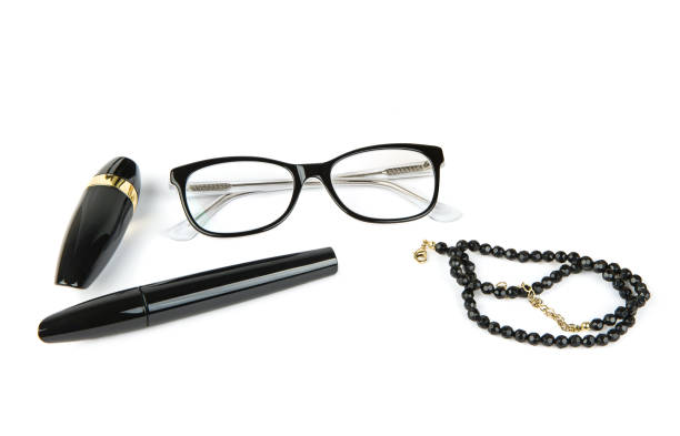 istock Lipstick, mascara, glasses and black beads isolated on white. 1488384415