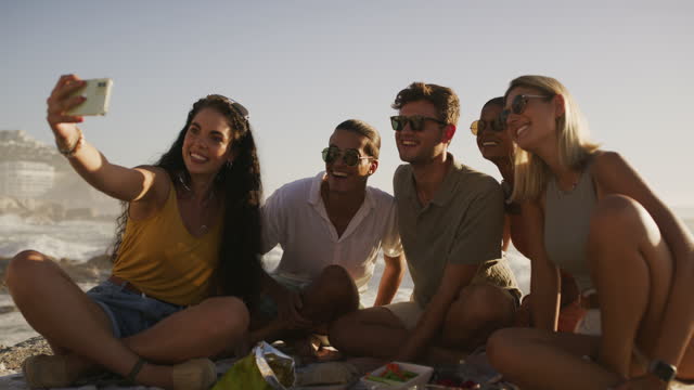 Selfie, happy and friends smile at beach for social media post, travel blog and memories by ocean. Spring break, friendship and men and women relax for photo on holiday, weekend and summer vacation