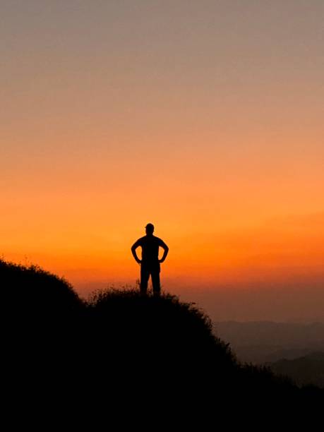 istock Silhouette man on mountain peak 1488387053