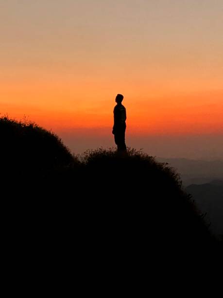 istock Silhouette male hiker standing on mountain peak 1488387133
