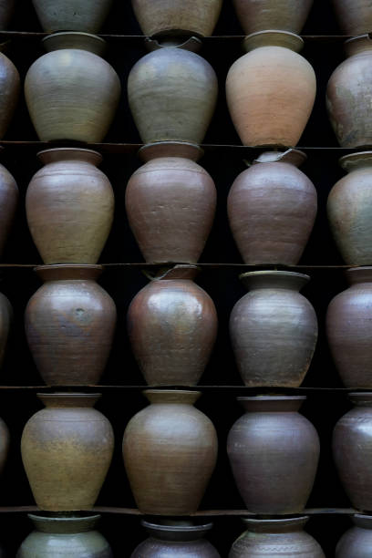 istock Old pottery earthenware jars on shelf with black wall 1488387231