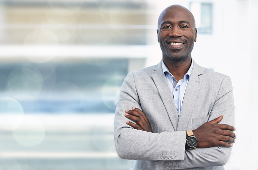 Smile, leadership and portrait of black man, confident ceo with mockup and blurred background. Vision, future and proud businessman, leader in growth and development of business in corporate Africa.