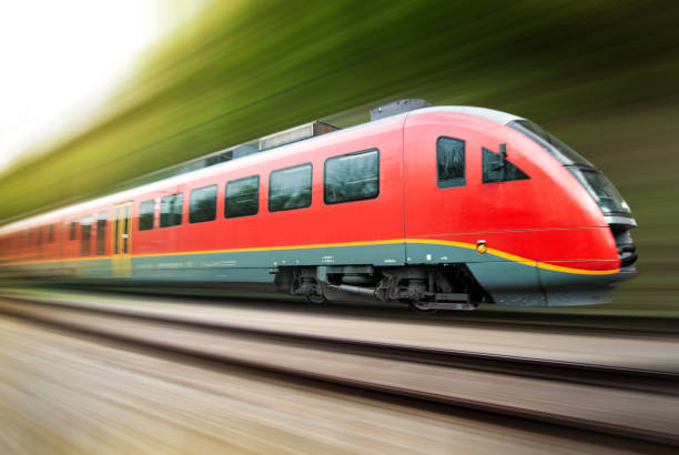 istock Speeding passenger train with motion blur against green countryside 1488391524
