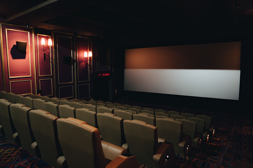 Empty movie theater with seats. Rows of void seats in cinema. Cinema theatre hall with empty armchairs. Cinema hall with number ten of seat. Movie entertainment