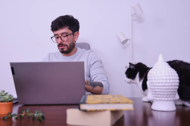 istock middle aged tattooed man studying at home 1488393031