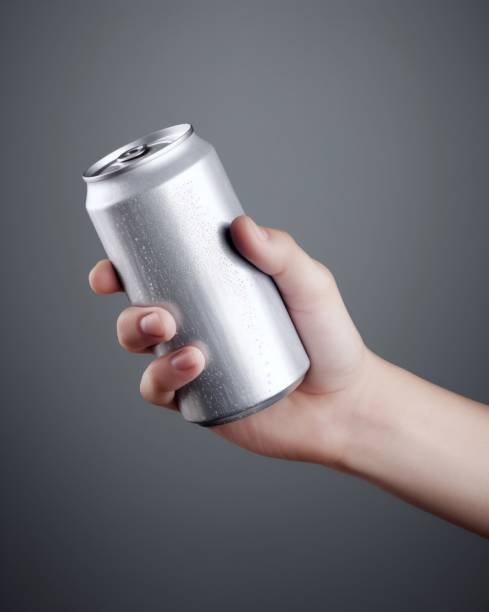 istock Aluminum can in hand on grey background, 1488394006