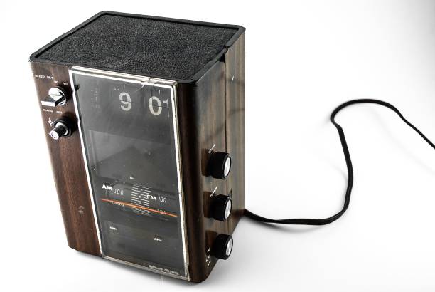 istock Antique radio featuring an attached clock face, set against a white background 1488394065