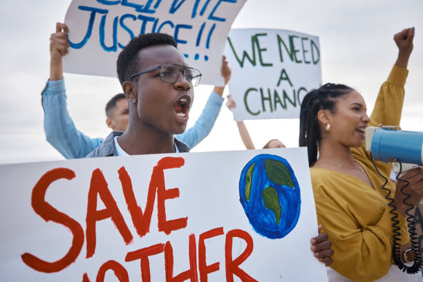 istock Climate change, protest poster and black man scream for freedom movement. Angry, crowd screaming and young people by the sea with world support for global, social and equality action at the beach 1488395966