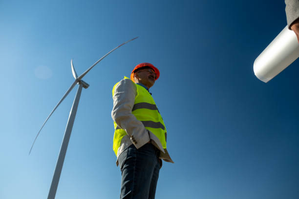 istock Technician meets manager of project under wind generator 1488396554