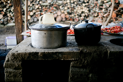 Traditional stoves used by residents in rural Indonesia, made of clay, fueled with wood, Cooking Food On Soil Stove With Dry Leafs And Wood In Village