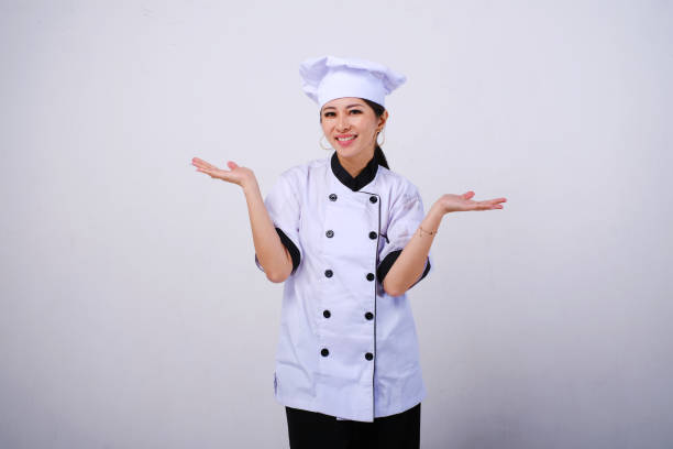 istock Smiling female Asian chef standing with open palms, warm welcome gesture 1488400749
