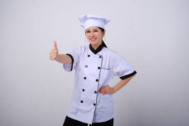 istock Smiling female Asian chef standing giving thumb up 1488400809