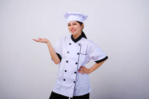 istock Smiling female Asian chef with hands open palms gesture 1488400819