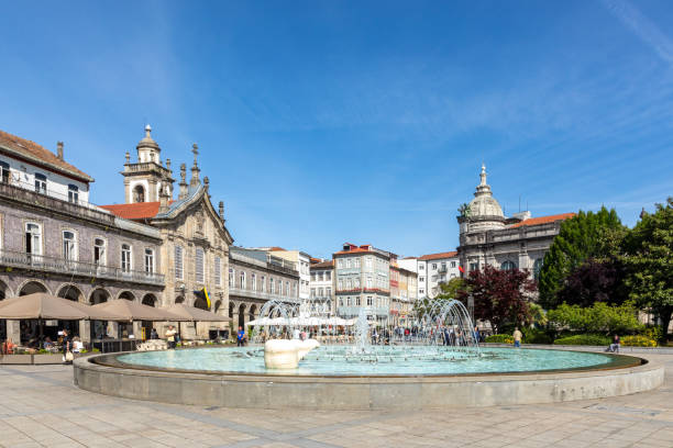 sunset view of Praca da Republica in the historical center of Braga, Portugal with reflection in fountain stock photo