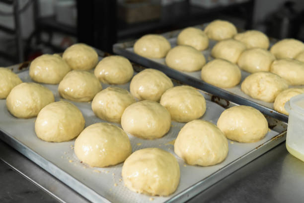 istock Balls of Dough Placed On a Cooking Paper in a Baking Pan 1488401286