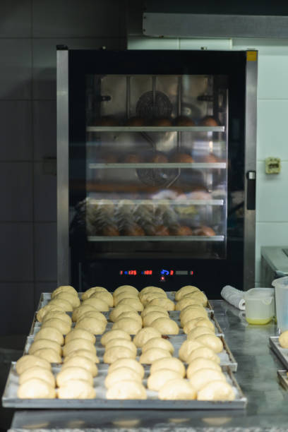 istock Balls of dough in a baking pan, going into a restaurant oven 1488402102