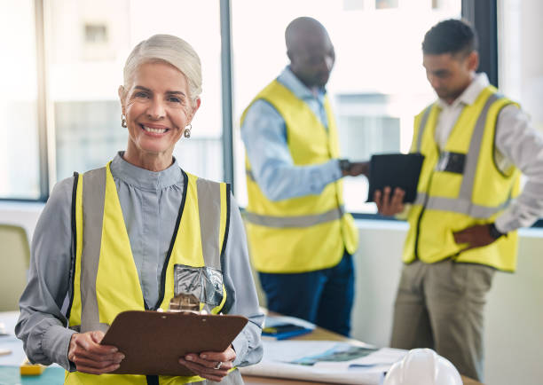 istock Senior woman, portrait and engineering clipboard for construction data check and project blueprint. Architecture team, building plans and proud elderly industrial employee with staff and smile 1488404080
