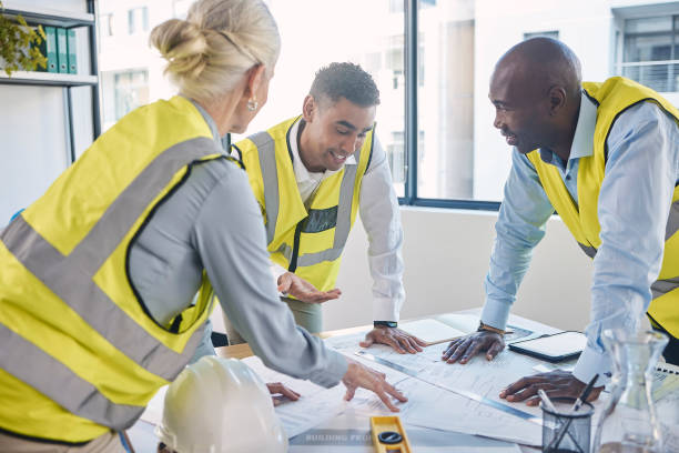 istock Architect, building and construction team in planning strategy, blueprints or meeting for project layout at office. Group of diverse engineers or contractors discussing floor plan or architecture 1488404081