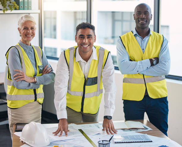 istock Team, portrait and engineering management staff with construction gear and project blueprint. Architecture staff, building plans and proud diversity of industrial employees with collaboration 1488404105