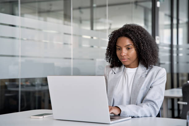 istock Middle age business woman working, browsing, and typing on touchscreen laptop. 1488405163